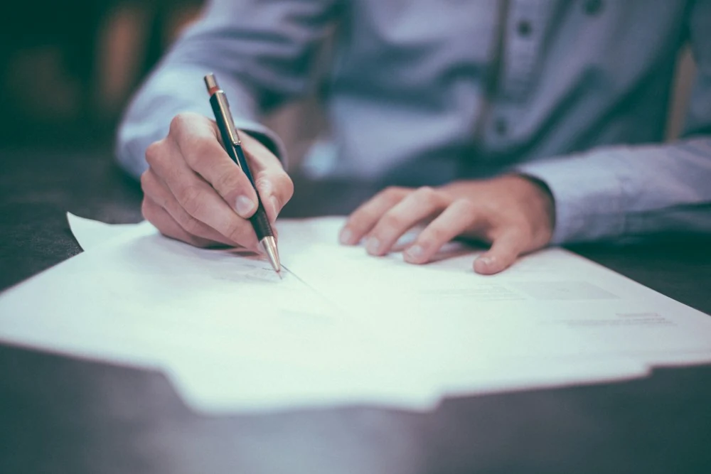 Documents being organized and signed at a desk